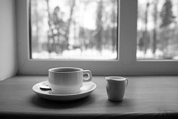 Coffee cup and milk on windowsill — Stock Photo, Image