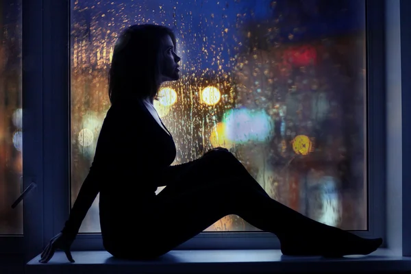 Girl sitting near window — Stock Photo, Image