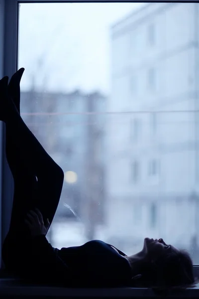 Girl sitting near window — Stock Photo, Image