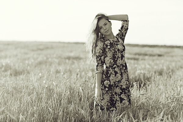 Girl in the rustic landscape of wheat at l sunset