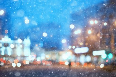 Soyut kar arka planda bulanık şehir ışıkları, kış tatili yeni yıl