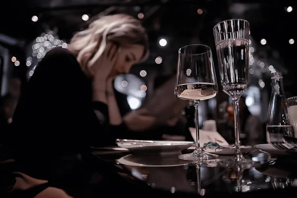 restaurant table view evening wine glass, friends at the party