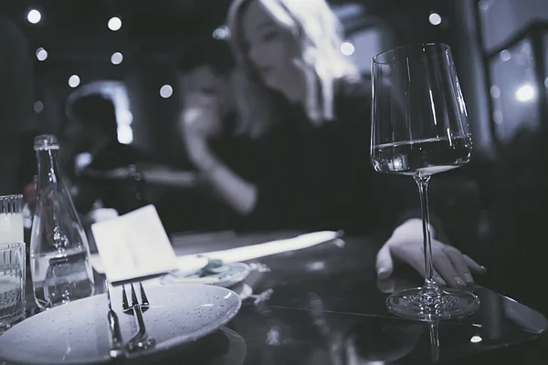 restaurant table view evening wine glass, friends at the party