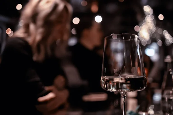 restaurant table view evening wine glass, friends at the party