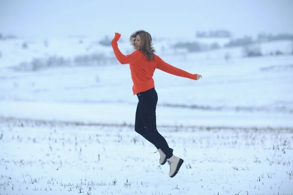 winter snow field woman happiness jumping and running in the field, new year holidays vacation freedom concept