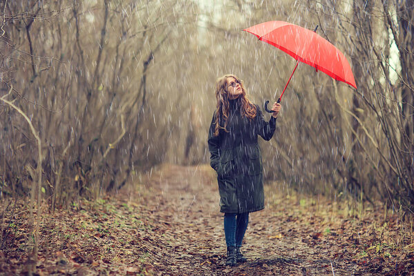 Seasonal autumn portrait, sad girl with umbrella, november seasonal virus immunity on a walk