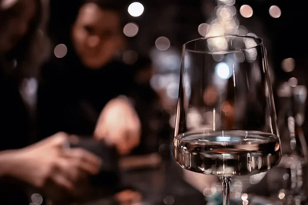 restaurant table view evening wine glass, friends at the party