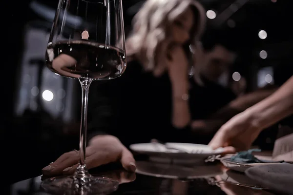 restaurant table view evening wine glass, friends at the party