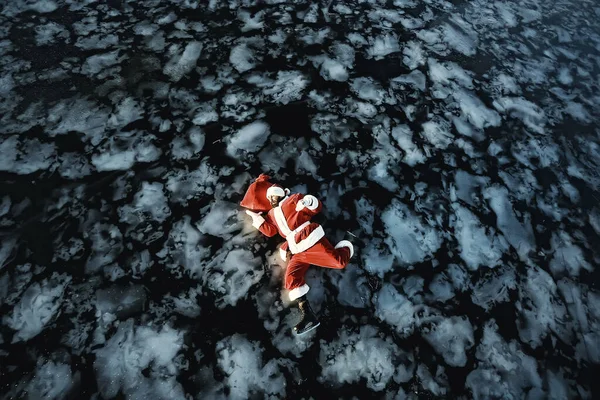 サンタクロースは湖の氷の上でスケート 横になり サンタ負け犬 — ストック写真