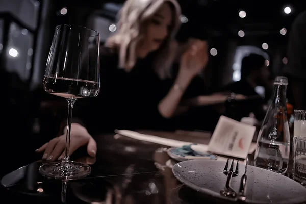 restaurant table view evening wine glass, friends at the party