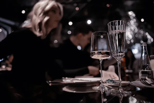 restaurant table view evening wine glass, friends at the party