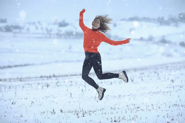 winter snow field woman happiness jumping and running in the field, new year holidays vacation freedom concept