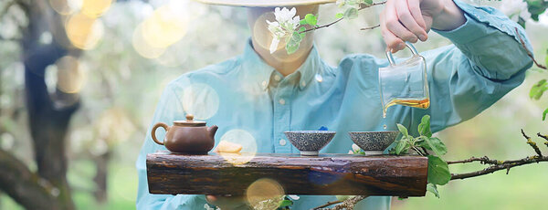 spring tea ceremony in asia, abstract fresh garden background man master