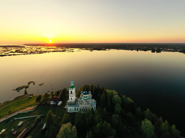 summer landscape in russia sunset, church on the banks of the river christianity orthodoxy