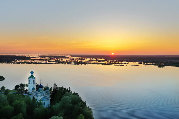 summer landscape in russia sunset, church on the banks of the river christianity orthodoxy