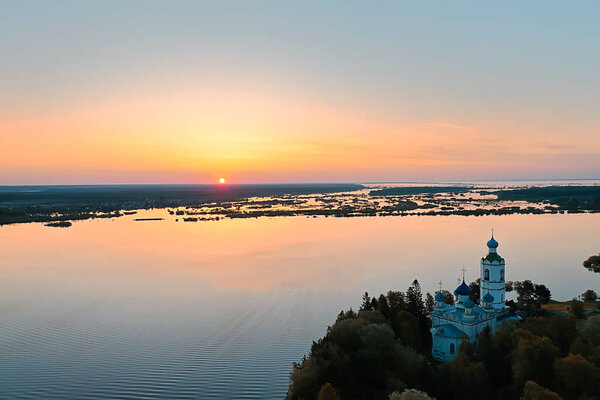 summer landscape in russia sunset, church on the banks of the river christianity orthodoxy