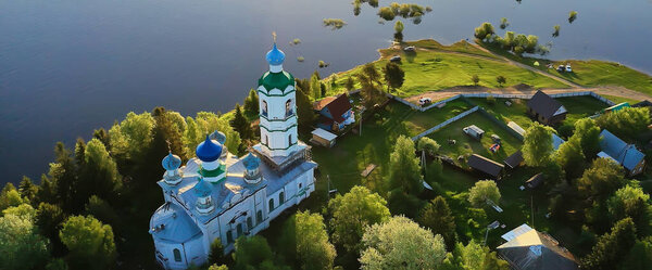 summer landscape in russia sunset, church on the banks of the river christianity orthodoxy