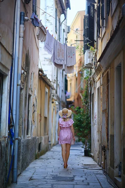 tourism summer old town female, europe mediterranean, young woman traveler, back straw hat view