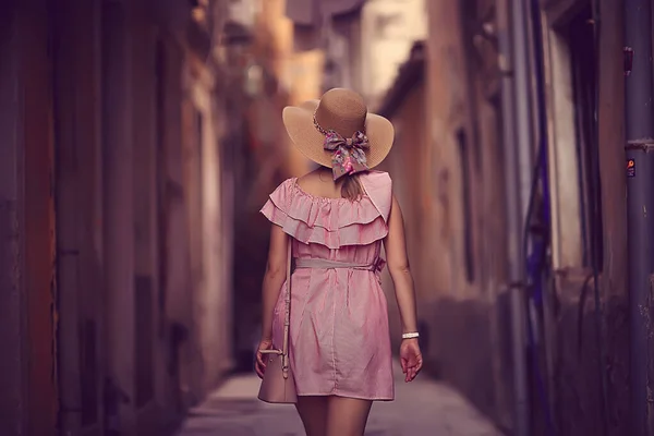 tourism summer old town female, europe mediterranean, young woman traveler, back straw hat view