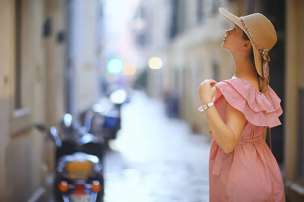 tourism summer old town female, europe mediterranean, young woman traveler, back straw hat view