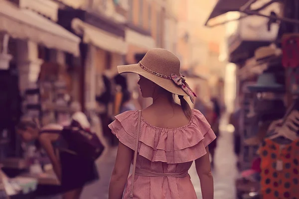 tourism summer old town female, europe mediterranean, young woman traveler, back straw hat view