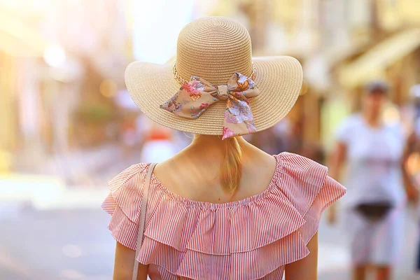 tourism summer old town female, europe mediterranean, young woman traveler, back straw hat view