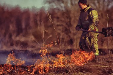 Vologda, Rusya - 22 Nisan: Çimler yanıyor, yangın devam ediyor, bir itfaiyeci 22 Nisan 2019 Vologda, Rusya 'daki orman yangınını söndürdü