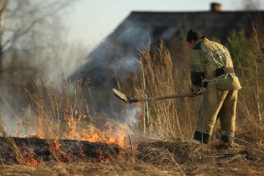 Vologda, Rusya - 22 Nisan: Çimler yanıyor, yangın devam ediyor, bir itfaiyeci 22 Nisan 2019 Vologda, Rusya 'daki orman yangınını söndürdü