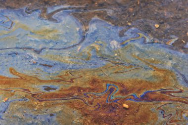 Benzin birikintisi, ıslak yağ çok renkli gökkuşağı kirliliği sızıntısı.