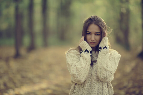Sad girl in autumn park, stress loneliness young person female