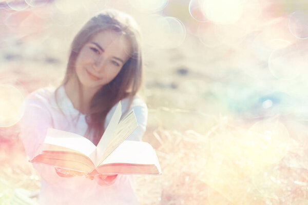 female reading a book in a field summer straw woman reading a book student studying summer vacation from school girl in the field