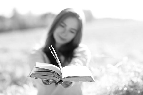 female reading a book in a field summer straw woman reading a book student studying summer vacation from school girl in the field