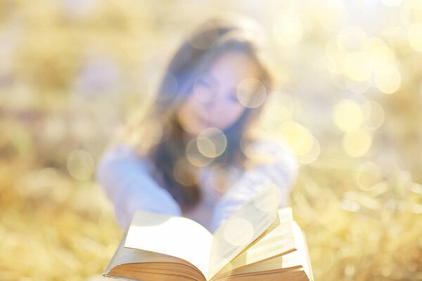 female reading a book in a field summer straw woman reading a book student studying summer vacation from school girl in the field