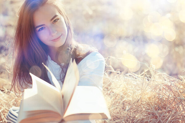 female reading a book in a field summer straw woman reading a book student studying summer vacation from school girl in the field