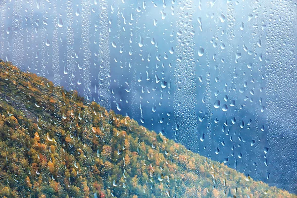 rain window view, water drops on glass view forest and mountains landscape background