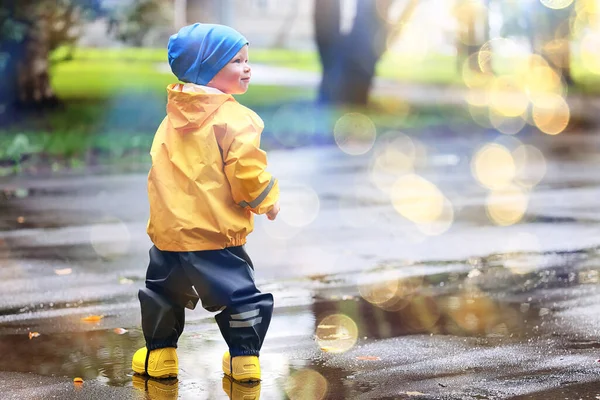 Boy Playing Outdoors Puddles Autumn Childhood Rubber Shoes Raincoat Yellow — Stock Photo, Image
