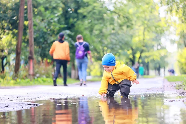 Boy Playing Outdoors Puddles Autumn Childhood Rubber Shoes Raincoat Yellow — Stock Photo, Image