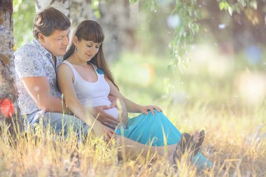 çim üzerinde yalan hamile kadın ve erkek