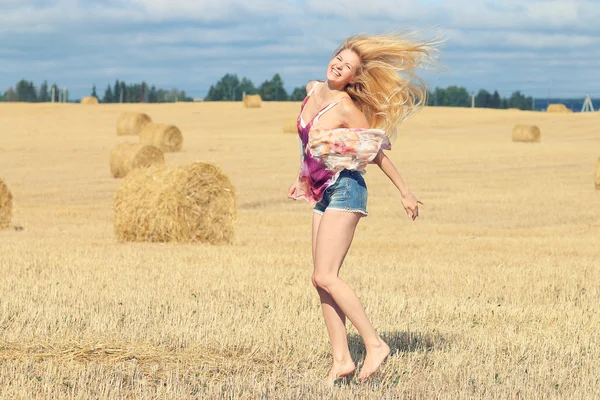 Mujer rubia salta en campoΞανθιά γυναίκα άλματα στον τομέα — Φωτογραφία Αρχείου