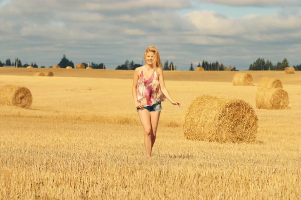 Woman running on the autumn field — Stock Photo, Image