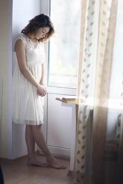 Girl sitting near window Stock Photo by ©xload 114087068