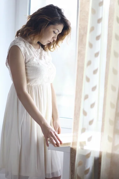 Girl standing at the window — Stock Photo, Image