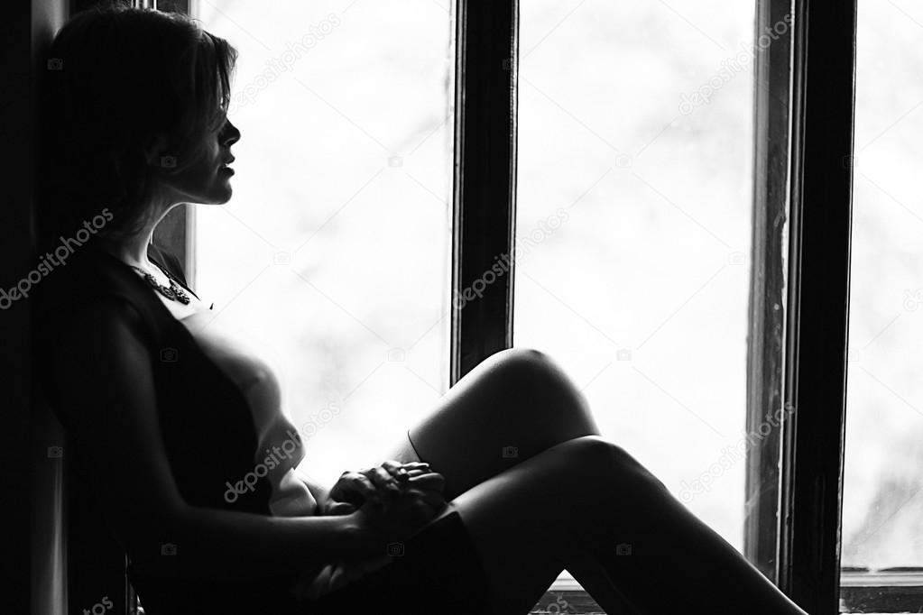 Woman sitting on the windowsill