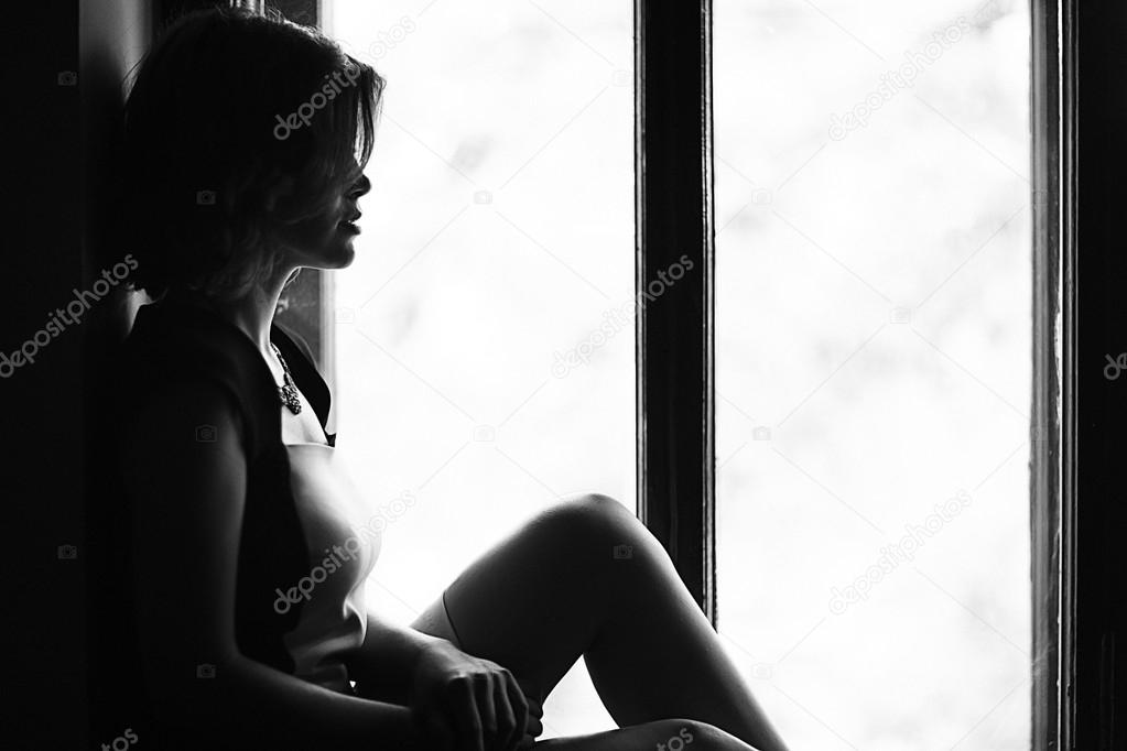 Woman sitting on the windowsill