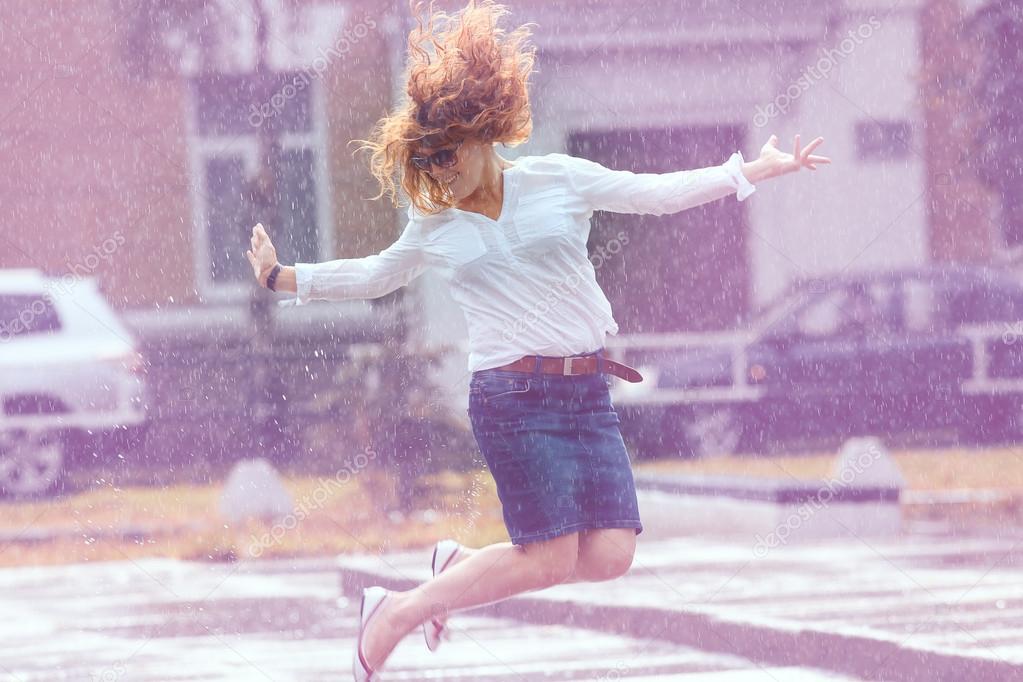 Girl jumping in the puddle