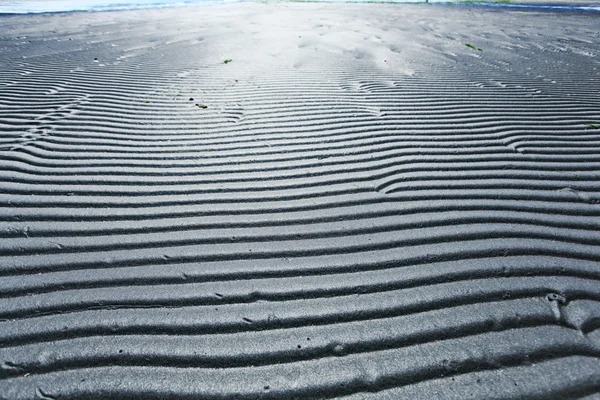 Сірий пісок пляжу текстури — стокове фото