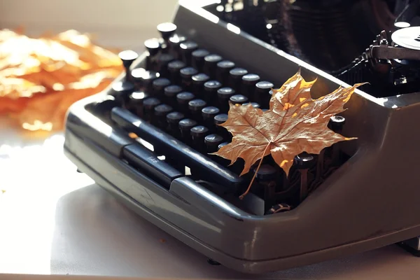 Máquina de escrever com folha de outono — Fotografia de Stock