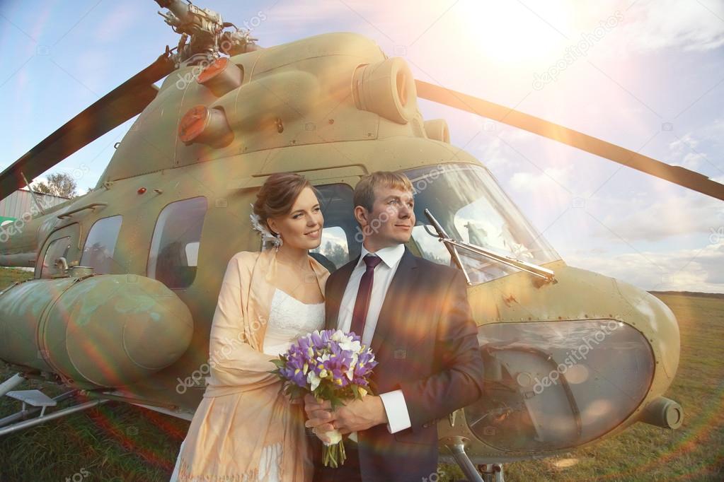 Wedding couple at helicopter