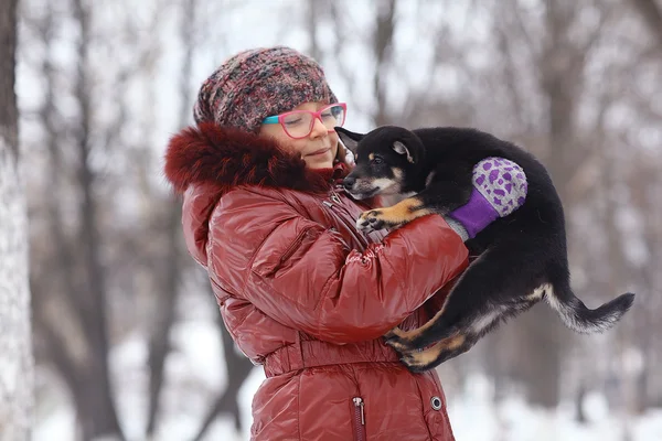 Girl and puppy in winter — Stock Photo, Image