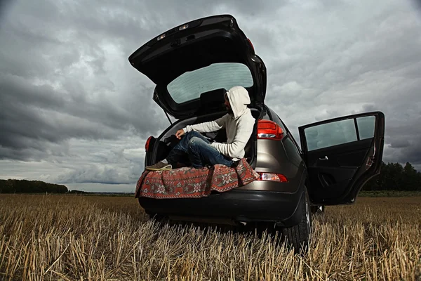 Man traveler in car trunk — Stock Photo, Image